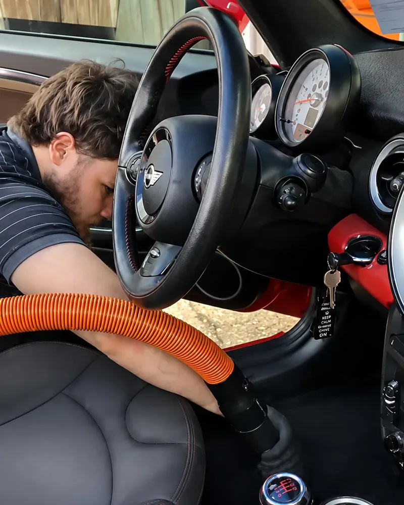 Tiger Town Detailing vacuuming out a MINI Cooper interior in Baton Rouge, LA